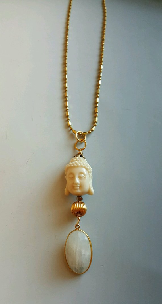 White Buddha (resin) with oval faceted moonstone in gold vermeil frame, on brass decorative chain