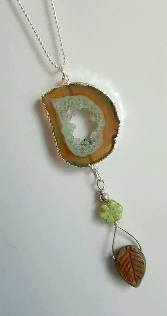 Green and amber colored open Agate drusy pendant, sterling edges and bails, drop green glass flower and leaf, all on sterling ball chain