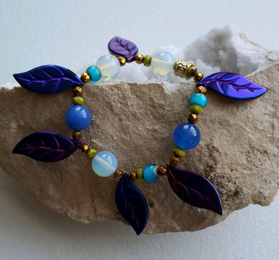 Beautiful purple iridescent hematite leaves, agate blue beads, opalite round beads, glass beads, gold tube bead, on elastic for comfort