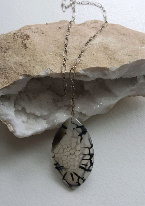Lovely marquis-shaped light colored dragon vein agate with black accent on sterling short-long oxidized chain