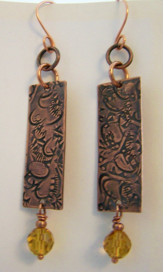 Hand hammered designs into heated Copper with hand-forged copper wires and crystal drop