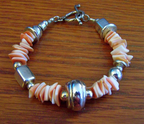 Lovely pink shell chips, shiny sterling beads of different shapes, and sterling toggle
