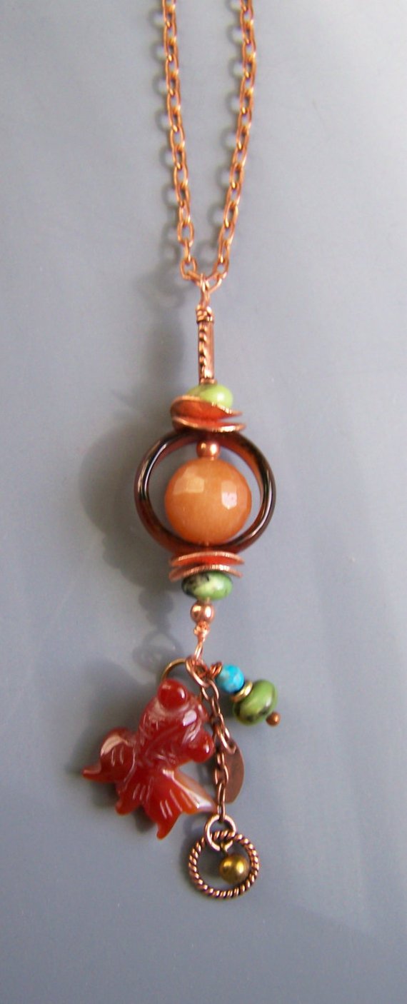 Long pendant on copper chain, glass disk with bling bead, Serpentine beads, copper curved disks, carnelian fish, dangles