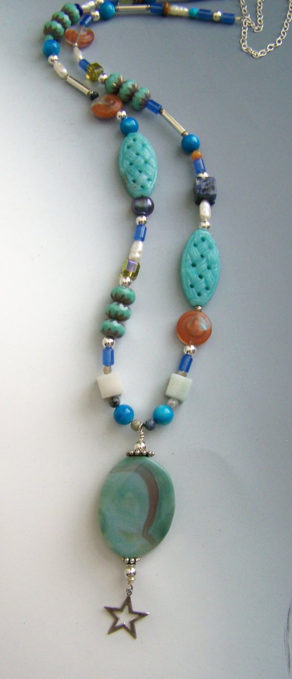 Colorful free form necklace with large turquoise colored agate drop, blue lapis, green, orange, stones and glass, sterling beads and chain