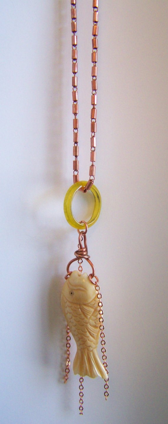 Carved bone fish dangling from copper wire, wrapped, green glass disk, long open copper chain with dangling copper chains