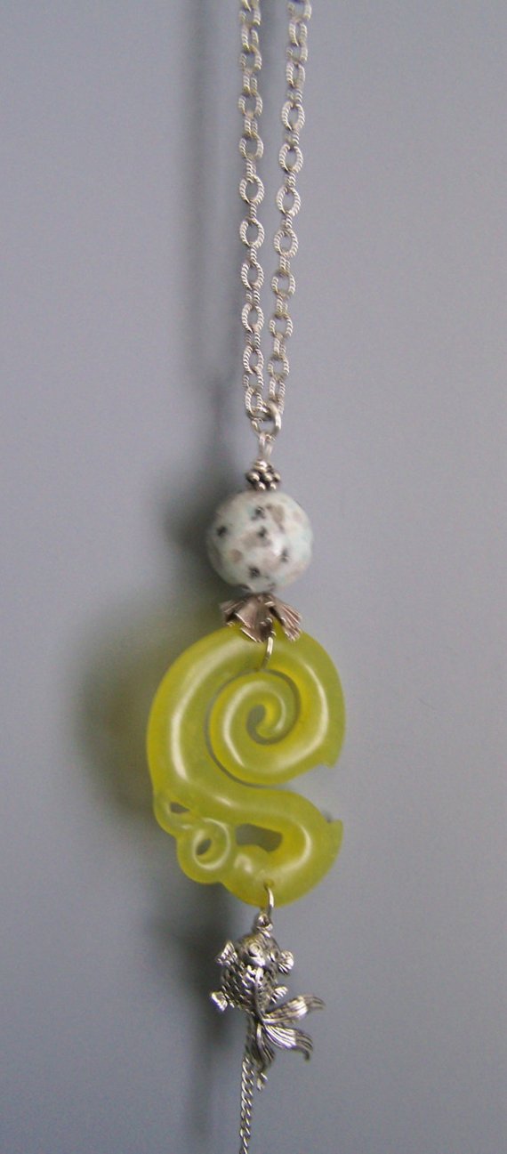 Large light green curved stone (jade?), sterling links, silver fish and chain dangles, large agate bead, on long pewter chain
